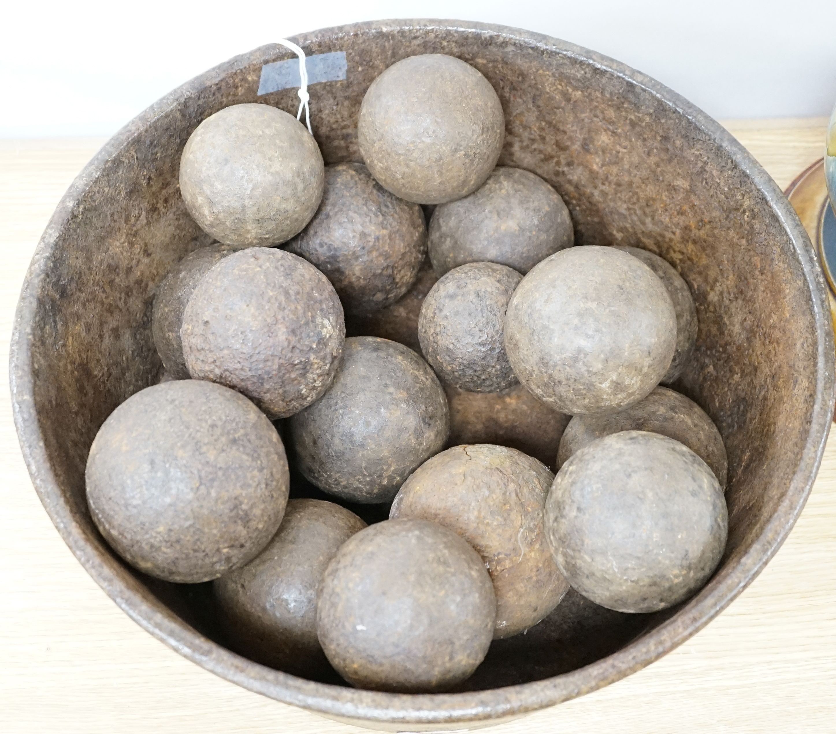 18 iron cannon balls in an iron bowl
